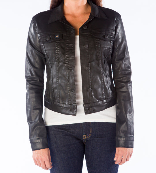 A woman standing wearing a black BlueHemp denim jacket and blue jeans.